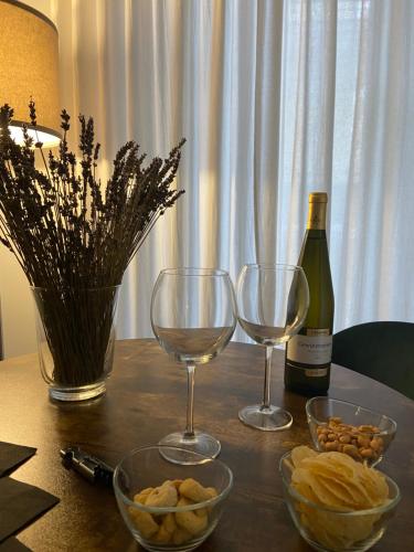 a table with two glasses and a bottle of wine at GUALTIERI LUXURY SUITE in San Giorgio a Cremano