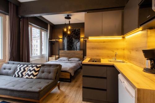 a kitchen with a couch and a bed in a room at STaYLE in Istanbul