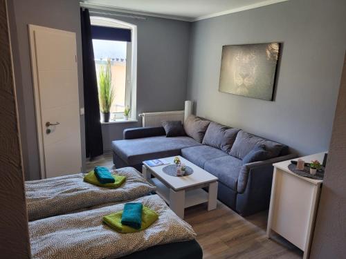 a living room with a couch and a table at Flensburg City - 24h in Flensburg