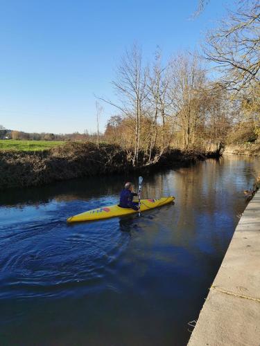 a man in a yellow kayak on a river at Grande maison détente & loisirs in Sargé-sur-Braye