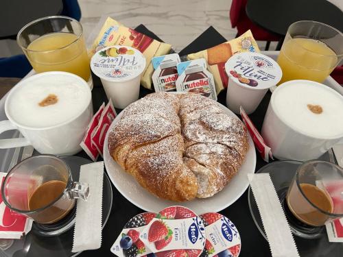 a table with a plate of bread and some drinks at GUALTIERI LUXURY SUITE in San Giorgio a Cremano