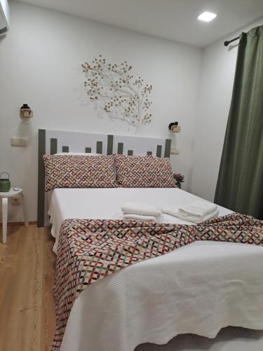 a bedroom with a bed with two towels on it at VillaGarcia-Casa da Peneira in Terras de Bouro