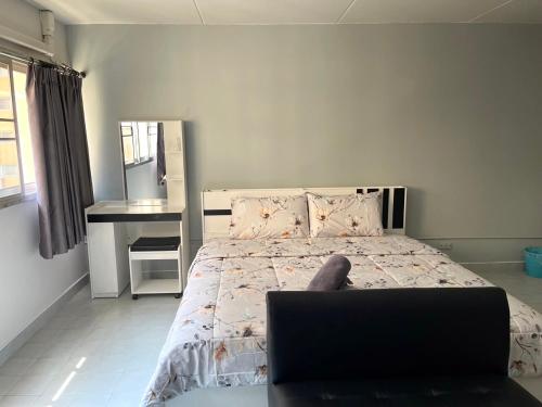 a bedroom with a bed with a laptop on it at Impact Arena C3 Milo in Nonthaburi