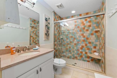 a bathroom with a toilet and a shower and a sink at Casa Aqua in Saint Augustine