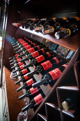 a bunch of wine bottles in a wine cellar at Almaty Grand Erbil Hotel in Almaty