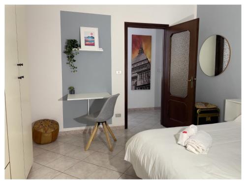 a bedroom with a bed and a desk and a chair at Lingotto Side House - Affitti Brevi in Turin