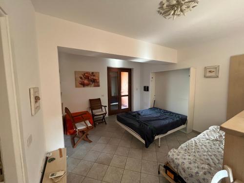 a bedroom with a bed and a chair in a room at Ampio monolocale in Golfo Aranci