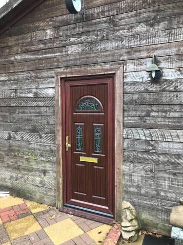 a wooden door on the side of a building at The Barn in Trotterscliffe