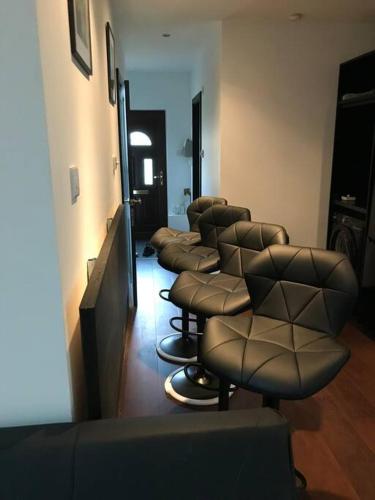 a waiting room with a row of barber chairs at The Barn in Trotterscliffe