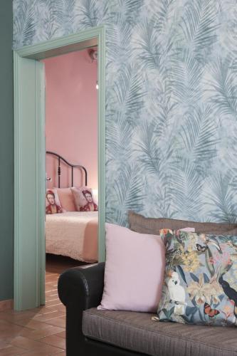 a living room with a couch and a mirror at Green Coast House 4 in Piombino