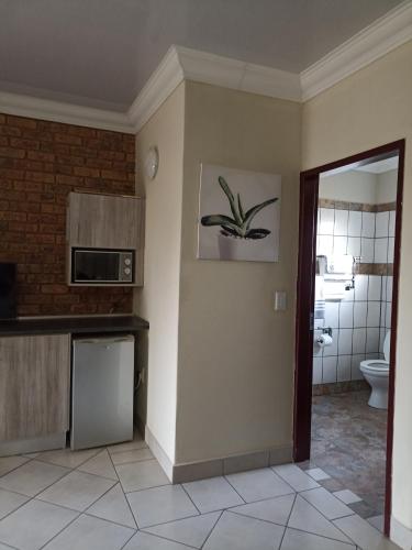 a room with a kitchen with a sink and a toilet at 4 SEASONS COUNTRY CLUB in Bronkhorstspruit