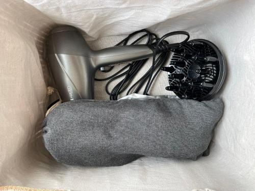 a hair dryer and some wires in a cloth at Premium Apartment in quiet & historical area in Rīga