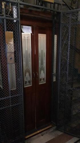a wooden door in a room with wrought iron fences at Soba Marinko in Rijeka
