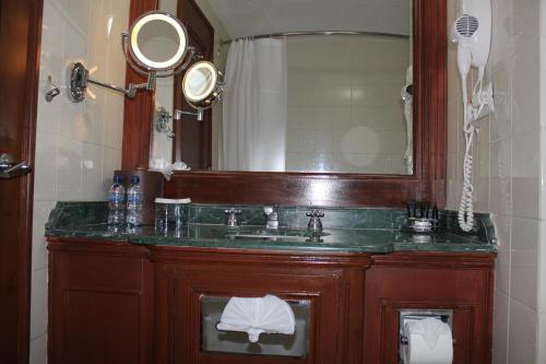 a bathroom with a sink and a mirror at Hotel Las Americas in Guatemala