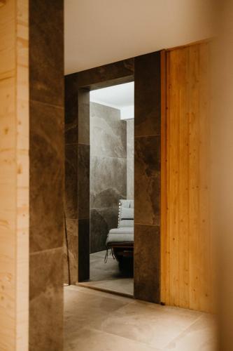 an open door into a room with a chair at Waldhotel Seefeld in Seefeld in Tirol
