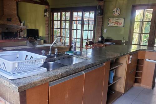 a kitchen with a sink and a counter top at Casa ampla no Laranjal in Pelotas