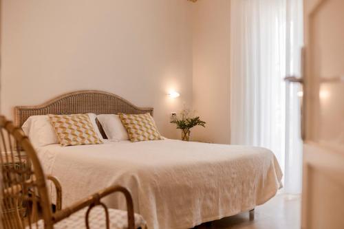 a bedroom with a bed with pillows and a window at Villa Arizona in Milano Marittima