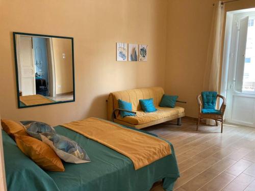 a bedroom with a bed and a mirror and a chair at Casa Dalfea in Mazara del Vallo