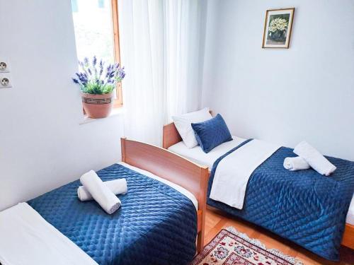 a room with two beds and a window at Apartments Villa Rosa in Split