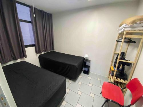 Cette petite chambre comprend un lit et une chaise. dans l'établissement Apart 2 dorm. Prox Cambuí Wi-Fi Gar Var Note Pet, à Campinas