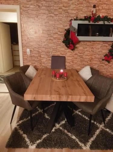 a wooden table with two chairs and a laptop on it at Apartment mit 3 Zimmer in Wolfratshausen