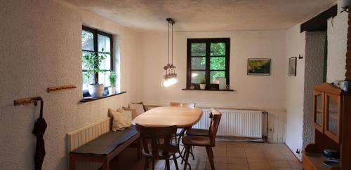 a kitchen with a table and chairs in a room at Ferienhaus Neumühle in Lutzerath