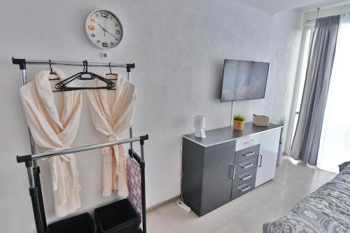 a bedroom with a bed and a clock on the wall at Apartmán Bling s vírivkou Zemplínska Šírava in Kaluža