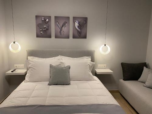 a bedroom with a bed with three pictures on the wall at Camelia luxury apartment in Karistos