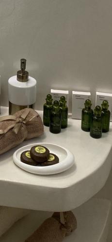 a counter with green jars and a plate of food at Camelia luxury apartment in Karistos