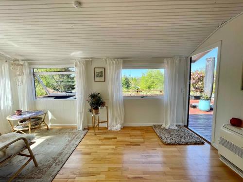 sala de estar con ventana grande y mesa en Nice Holiday Home Near Tisvilde Town And Beach, en Vejby