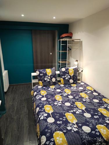 - une chambre avec un lit doté d'une couette bleue et jaune dans l'établissement Le Havre, 1 chambre , appartement Sympa en centre ville, au Havre
