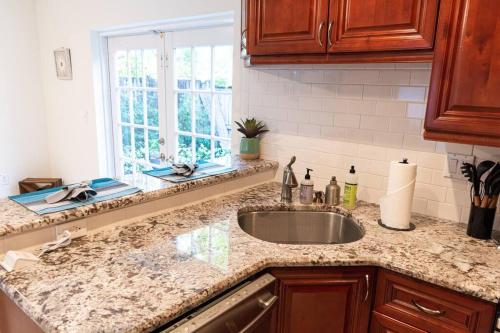 a kitchen counter with a sink and a window at Coconut Grove Hidden Sanctuary Townhouse in Miami