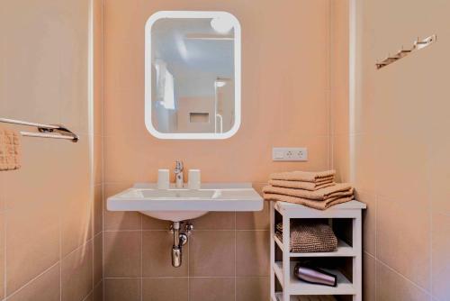 a bathroom with a sink and a mirror at 4Luxuriöses Ferienhaus in traumhafter Landschaft in Döbriach