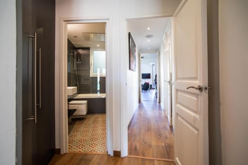 a hallway of a bathroom with a toilet and a sink at 41ARI1045- Fantastic and super spacious 3bed apartment in the Center in Barcelona