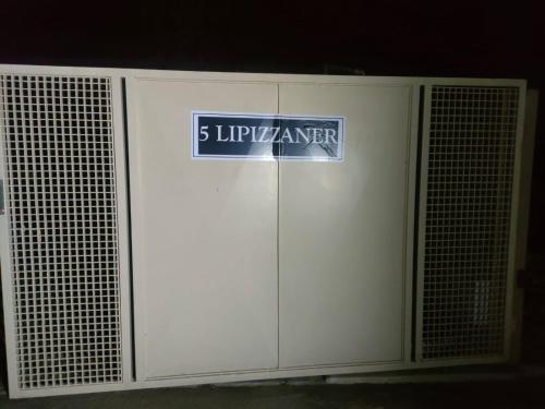 a white garage door with a sign on it at Lipizzaner Lodge - Kyalami, Midrand in Kyalami