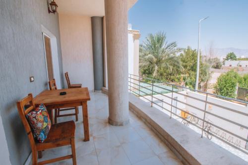 a room with a desk and chairs on a balcony at Swiss Royal DAHAB in Dahab