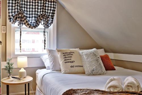 1 dormitorio con cama con almohadas y ventana en Ski VT Suite at The Bridgewater Inn, en Bridgewater