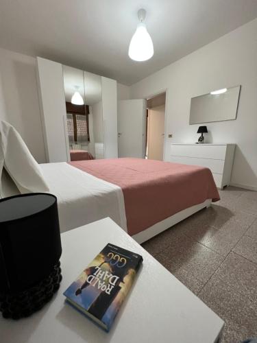 a hotel room with two beds and a book on a table at House of Lake Garda in Castelnuovo del Garda
