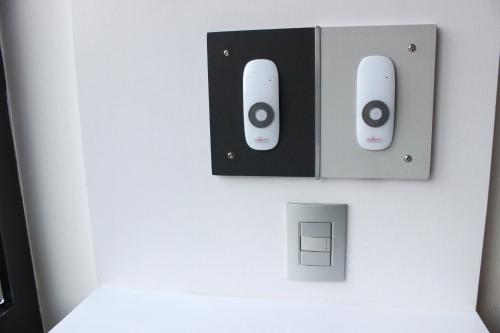 a wall with two speakers on a wall at WeEnjoy Hotels Grand Prix Aeropuerto CDMX in Mexico City