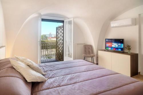 a bedroom with a large bed and a window at L’ape regina in Massa Lubrense