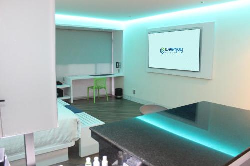 a living room with a table and a picture on the wall at WeEnjoy Hotels Grand Prix Aeropuerto CDMX in Mexico City