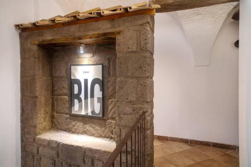 a brick fireplace with a sign on it at L’ape regina in Massa Lubrense