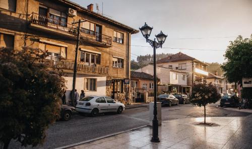 a street with a white car parked on the street at Sunset Lake hostel in Ohrid