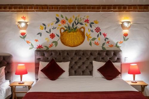 a bedroom with a bed with a vase on the wall at Hotel Spa Casa de Adobe Villa de Leyva in Villa de Leyva