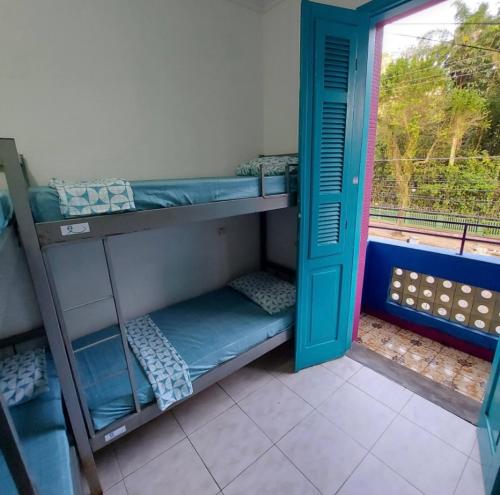 a room with two bunk beds and a window at Rolds Hostel in Santos