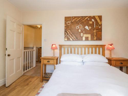 a bedroom with a large bed with two night stands at Beech Cottage in Ulverston