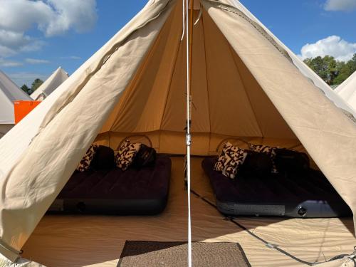 a tent with two beds inside of it at Festanation Oktoberfest Camp #2 in Munich
