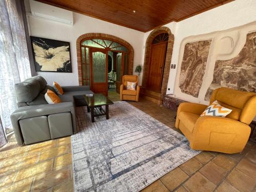 a living room with two couches and a table at Villa GAN EDEN in La Drova