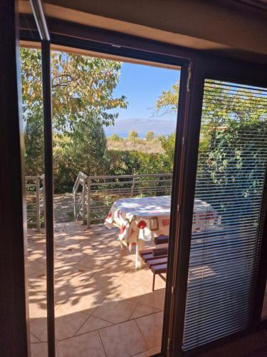 a sliding glass door with a table on a patio at Villa Altiparmak in Resen