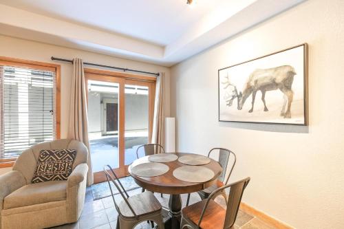 a living room with a table and a chair at Riverbend Centennial Run Condo: Ski In/Out in Breckenridge